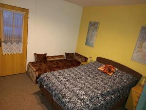 Posteľ alebo postele v izbe v ubytovaní Apartman Flora