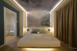 a bedroom with a large bed with two pillows on it at Alla Pergola in Bibione