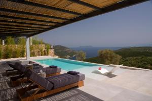 a swimming pool with lounge chairs and a view at Armante Supreme Villas-Villa Ismini in Fternón