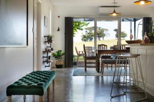 a kitchen and dining room with a table and chairs at Wayward Cottage in Daylesford