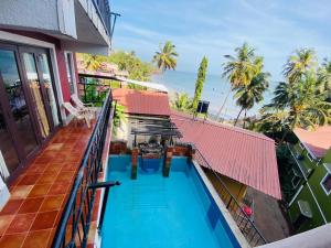 an overhead view of a swimming pool on the balcony of a house at Casa de Tidina and THE COUNTRY HOUSE in Dona Paula