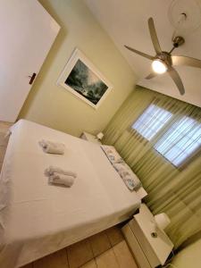 a bedroom with a bed with towels on it at Anthi Apartment in Paleo Tsifliki