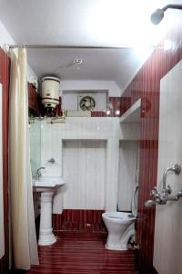 a bathroom with a sink and a toilet at Banasa Heritage Haveli in Jodhpur