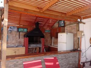 uma cozinha com um frigorífico e um fogão em Cómoda casa con piscina em Arica