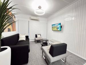 a living room with a couch and two chairs at Gem 7 Gladstone Apts - Suva CBD 2bdrm in Suva