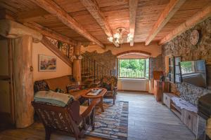 a living room with a couch and a table and a tv at Villa Danica with pool - Perka in Zvoneće