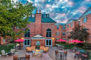 a large brick building with tables and chairs at Residence Inn by Marriott West Orange in West Orange