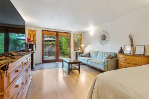 a bedroom with a bed and a couch and a table at Private Studio City Guest House in Los Angeles