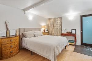 a bedroom with a bed and a dresser and a window at Private Studio City Guest House in Los Angeles