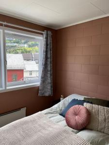 a bedroom with a bed with a large window at Leilighet i Odda sentrum in Odda