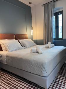 a bedroom with a large bed with towels on it at MOD 15 City Centre in Agios Nikolaos