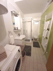 a bathroom with a washing machine in it at Apartment Lavanda in Tar