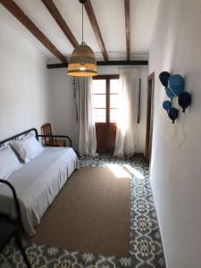 a bedroom with a bed with balloons and a chandelier at Bienvenido a Chez Matu in Capdepera