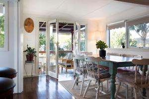 a dining room with a table and chairs at Zelman Cottage in Hepburn Springs