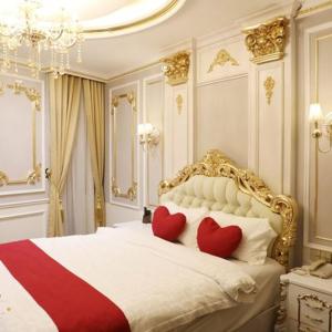 a bedroom with two red hearts on a white bed at ENJOY HOTEL 2 in Ho Chi Minh City