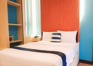 a bedroom with two beds and a window at iCheck inn Chill Patong in Patong Beach