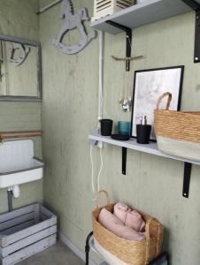 a room with shelves and a basket on the wall at La cabane du berger du parc national ESM in Froid-Chapelle