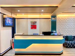 an office lobby with a colorful reception desk at iCheck inn Chill Patong in Patong Beach