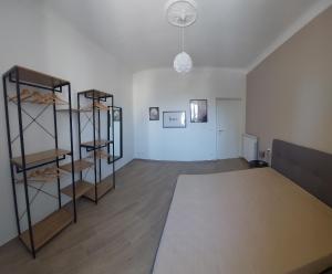 a room with a bed and shelves in it at FIUMARA MALL Apartment in Genoa