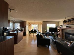 a living room with a couch and a kitchen at Spacious comfortable Air-Conditioned. Near airport! in Calgary
