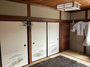 a room with sliding glass doors in a room at Guest house my home 