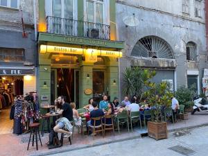 a group of people sitting at tables outside a restaurant at Cheers Porthouse in Istanbul