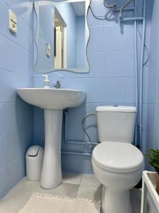 a blue bathroom with a toilet and a sink at The Valencia Stop in Valencia