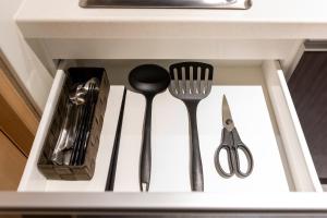 a drawer with utensils in a kitchen sink at Oyado Kawaramachi Gojo（御宿 河原町五条） in Kyoto