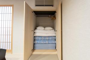 a walk in closet filled with lots of towels at Oyado Kawaramachi Gojo（御宿 河原町五条） in Kyoto