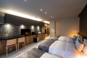 a living room with a couch and a tv in it at Oyado Kawaramachi Gojo（御宿 河原町五条） in Kyoto