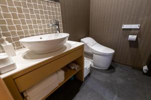 a bathroom with a sink and a toilet at Oyado Kawaramachi Gojo（御宿 河原町五条） in Kyoto