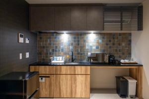 a kitchen with a sink and a counter top at Oyado Kawaramachi Gojo（御宿 河原町五条） in Kyoto