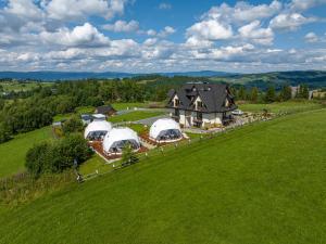 an aerial view of a large house with domes at Bukowina Glamp in Zakopane