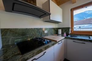 a kitchen with a sink and a window at Appartamento GreenWood in Vodo Cadore