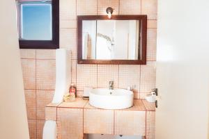 a bathroom with a sink and a mirror at Milos in Sikinos