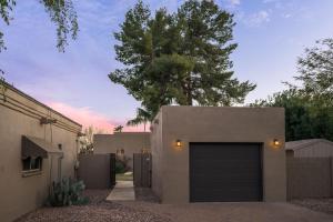 a house with a garage in front of a house at Luxury Guest House 2BA/2BR, Separate Building, Private Basketball Court, Prime Neighborhood in Scottsdale