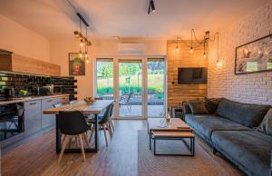 a living room with a couch and a table at Nad Lipami - apartament z tarasem blisko stoku Sczyrk in Szczyrk