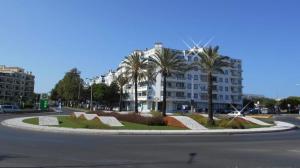a roundabout in the middle of a street with a building at Zurrinha holidays in Quarteira