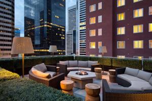 a rooftop patio with couches and tables and a city skyline at Residence Inn Denver City Center in Denver