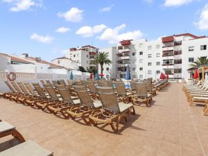 a row of chairs on a patio at a resort at GOLDEN HOLIDAYS, Heated Pool, Air C, Internet, Parking in Adeje