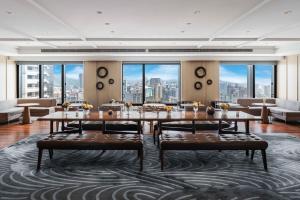 a dining room with a view of the city at Taipei Marriott Hotel in Taipei