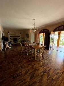 a dining room with a table and chairs on a wooden floor at Casa dei nonni in Alba Adriatica