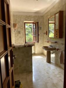a bathroom with a sink and a toilet and a mirror at Casa dei nonni in Alba Adriatica