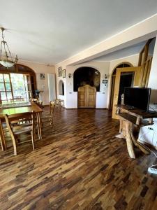 a living room with a wooden floor and a table at Casa dei nonni in Alba Adriatica