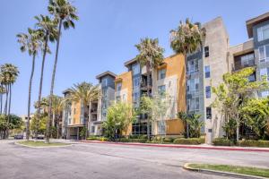 an empty street in front of apartment buildings with palm trees at El Segundo 1BR w Den Pool Lounge nr LAX LAX-795 in Hawthorne