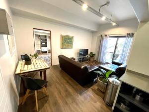 a living room with a couch and a table at Zeederberg Corner in Paarl