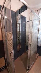 a glass shower in a bathroom with a mirror at Casale Battaglini in Castelnuovo Cilento