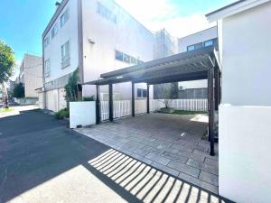 a building with a parking lot with a garage at 一棟貸切Villa誠雅 in Sapporo