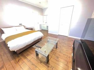 a bedroom with a bed and a table and a tv at 一棟貸切Villa誠雅 in Sapporo