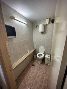 a bathroom with a toilet and a bath tub at Panorama rooms in Chios